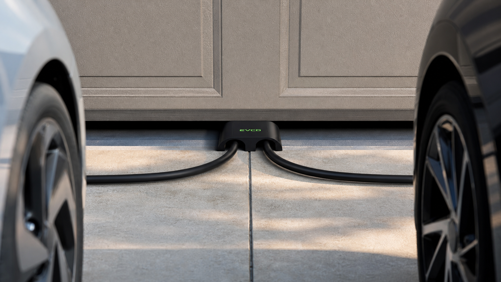 Digital visualization of two EV charging cables routed through an EVCD dual-channel protector beneath a closed garage door