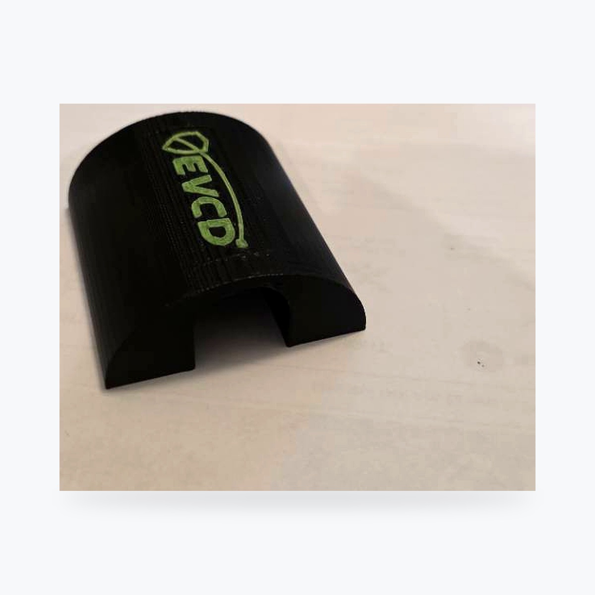 Clean catalog angled view of the current EVCD Arc Solo showing its rounded protective shell and green logo