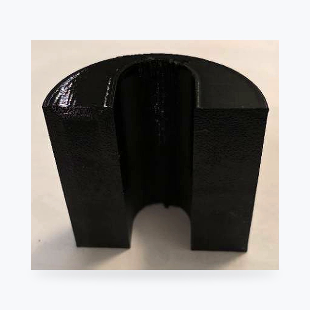 Current black PETG EVCD Arc Solo arched cable guard with the green shield-and-cable logo and one channel