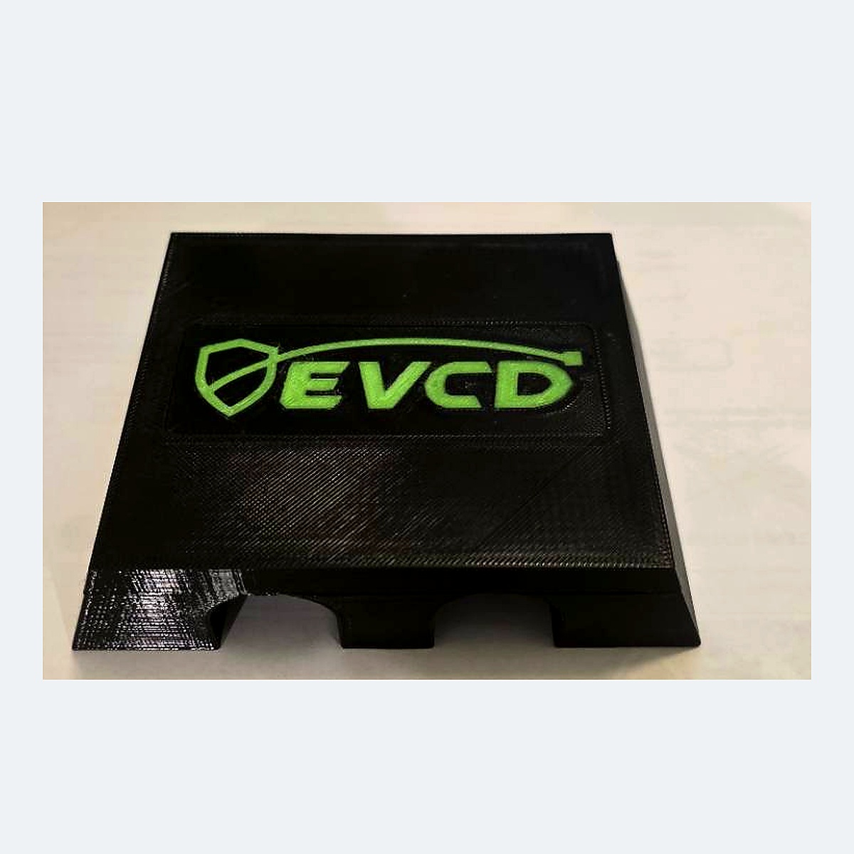 Current black PETG EVCD Ridge Duo flat-top cable guard with the green shield-and-cable logo and two channels
