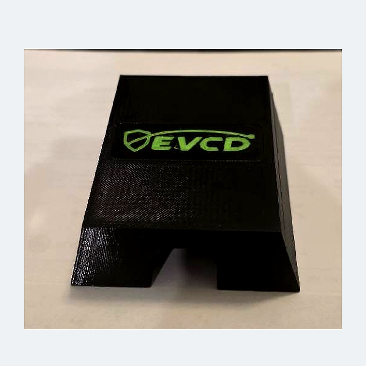 Current black PETG EVCD Ridge Solo flat-top cable guard with the green shield-and-cable logo and one channel