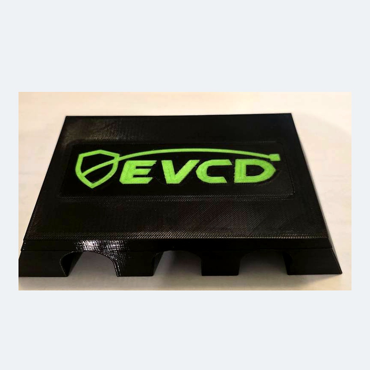 Current black PETG EVCD Ridge Trio flat-top cable guard with the green shield-and-cable logo and three channels